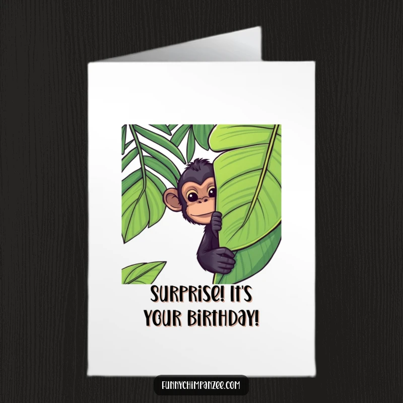 Funny Free Printable Birthday Card: A cute kawaii chimpanzee peeking mischievously from behind a large, vibrant jungle leaf.